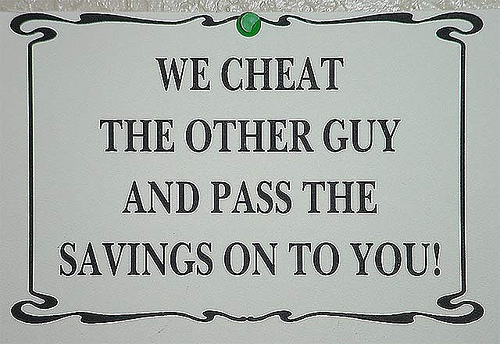 sign in antique store saying "we cheat..."